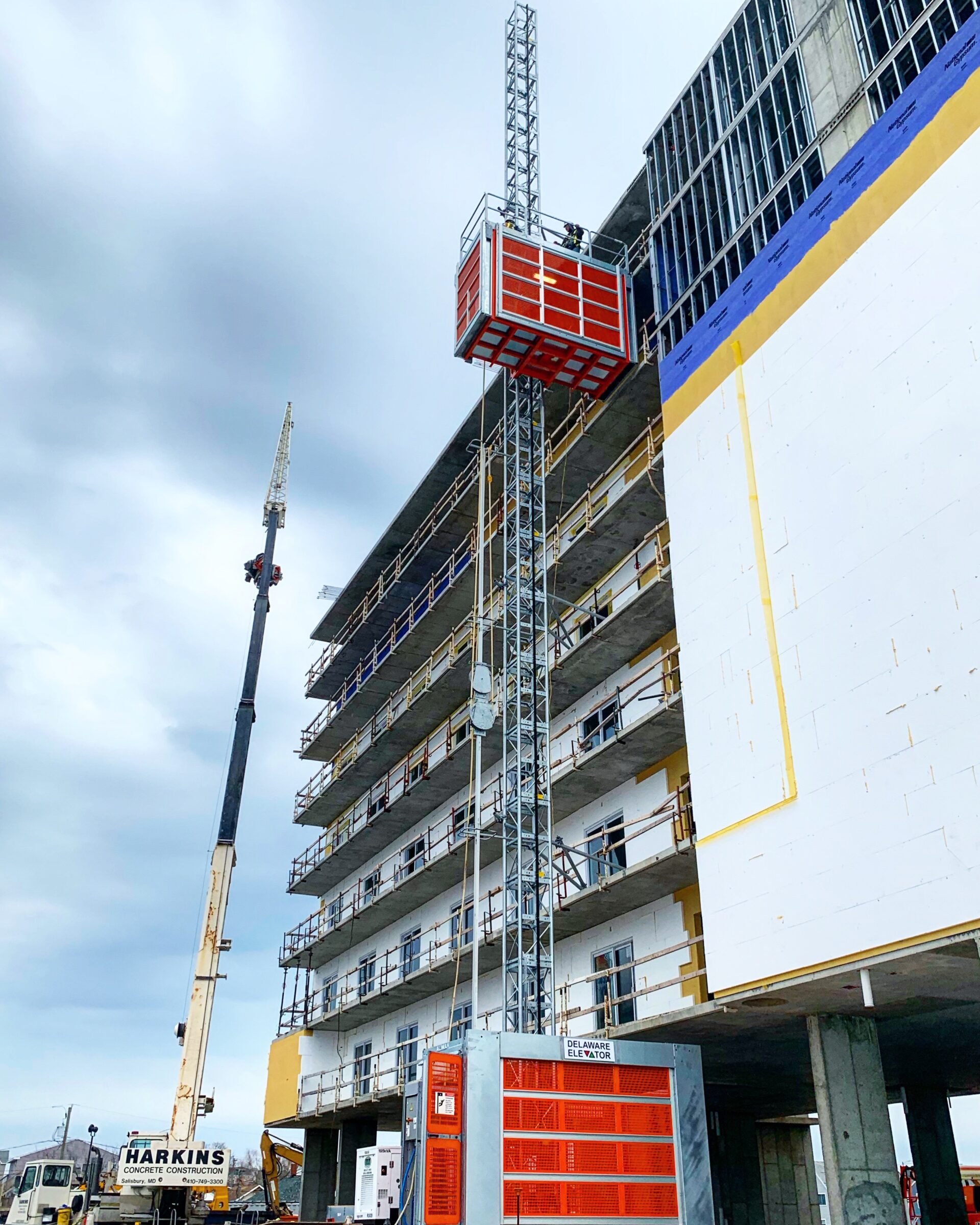 a tall building with a crane next to it