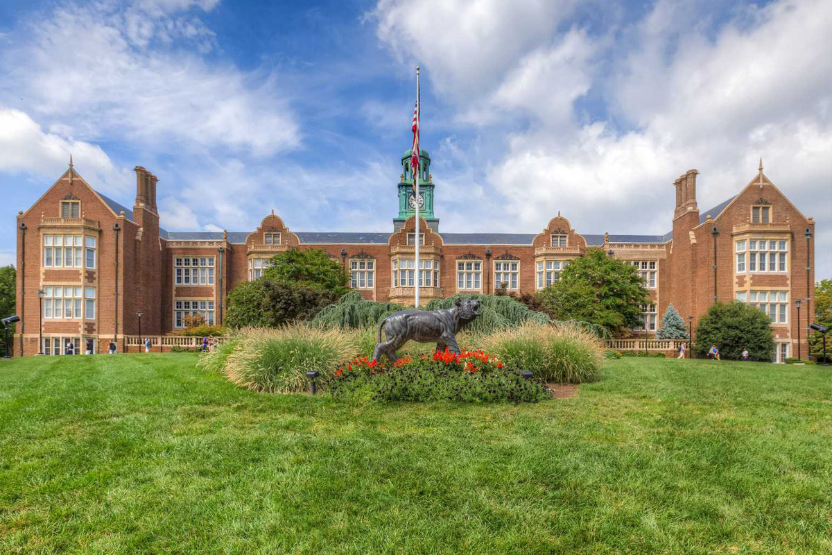 a large building with a horse statue in front of it